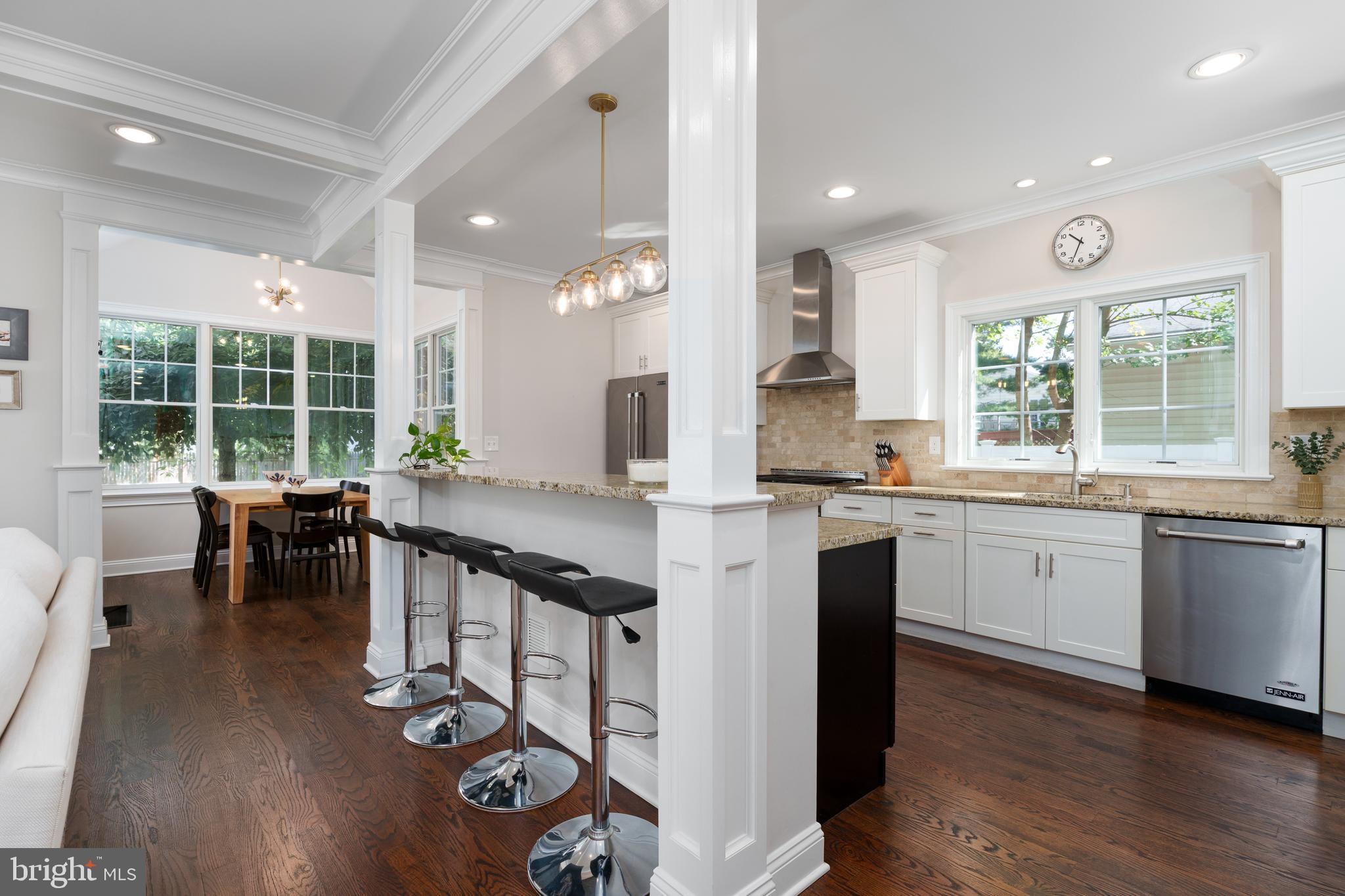 28 Hillside Road Princeton, NJ 08540 - Photo 12 of 31 a kitchen with stainless steel appliances granite countertop a stove top oven a sink a dining table and chairs with wooden floor