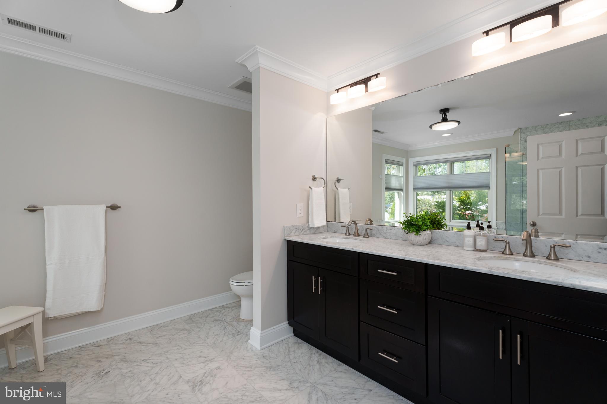 28 Hillside Road Princeton, NJ 08540 - Photo 19 of 31 a bathroom with a double vanity sink a toilet and a mirror