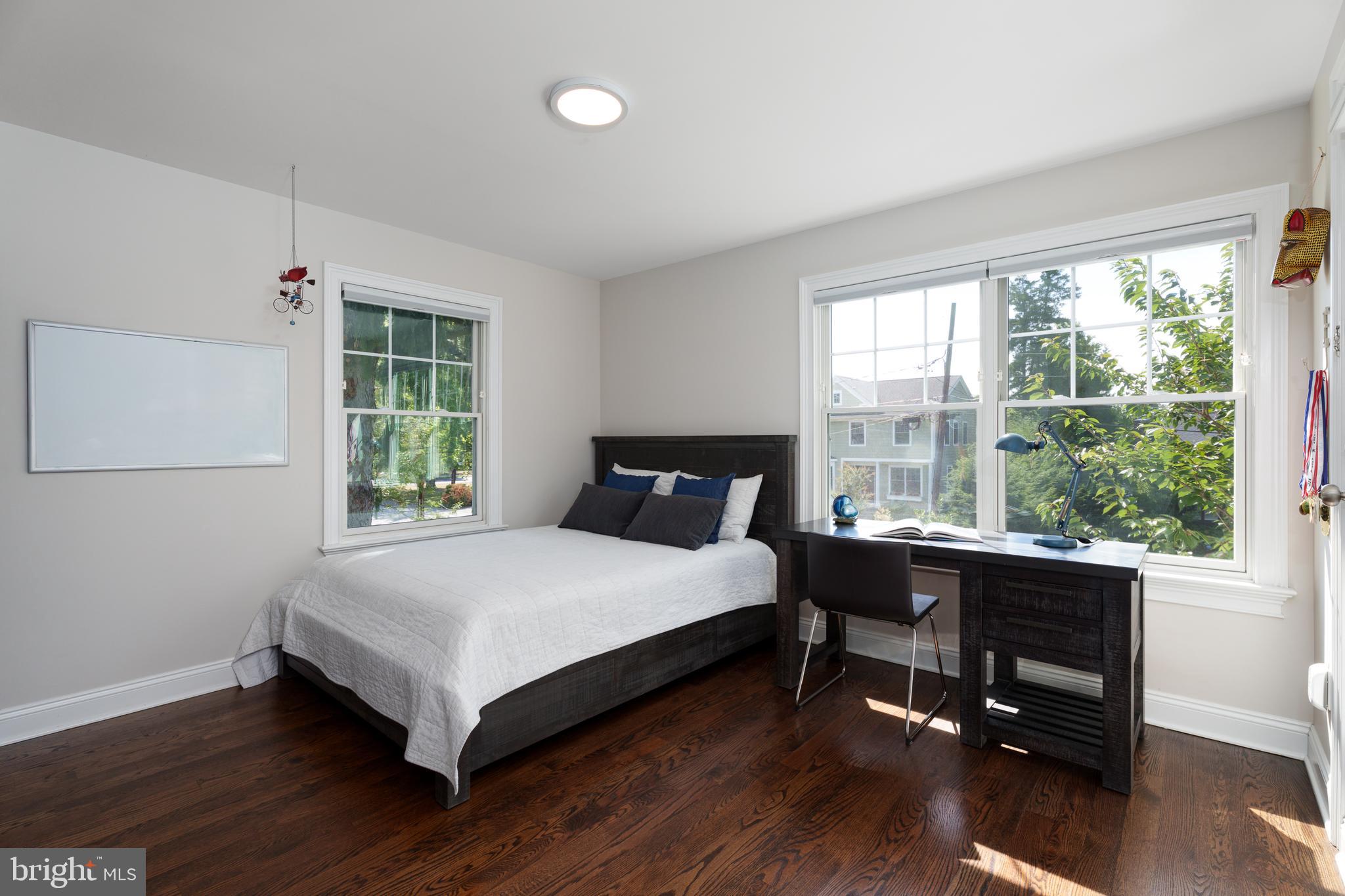 28 Hillside Road Princeton, NJ 08540 - Photo 21 of 31 a bedroom with a bed a table and a large window