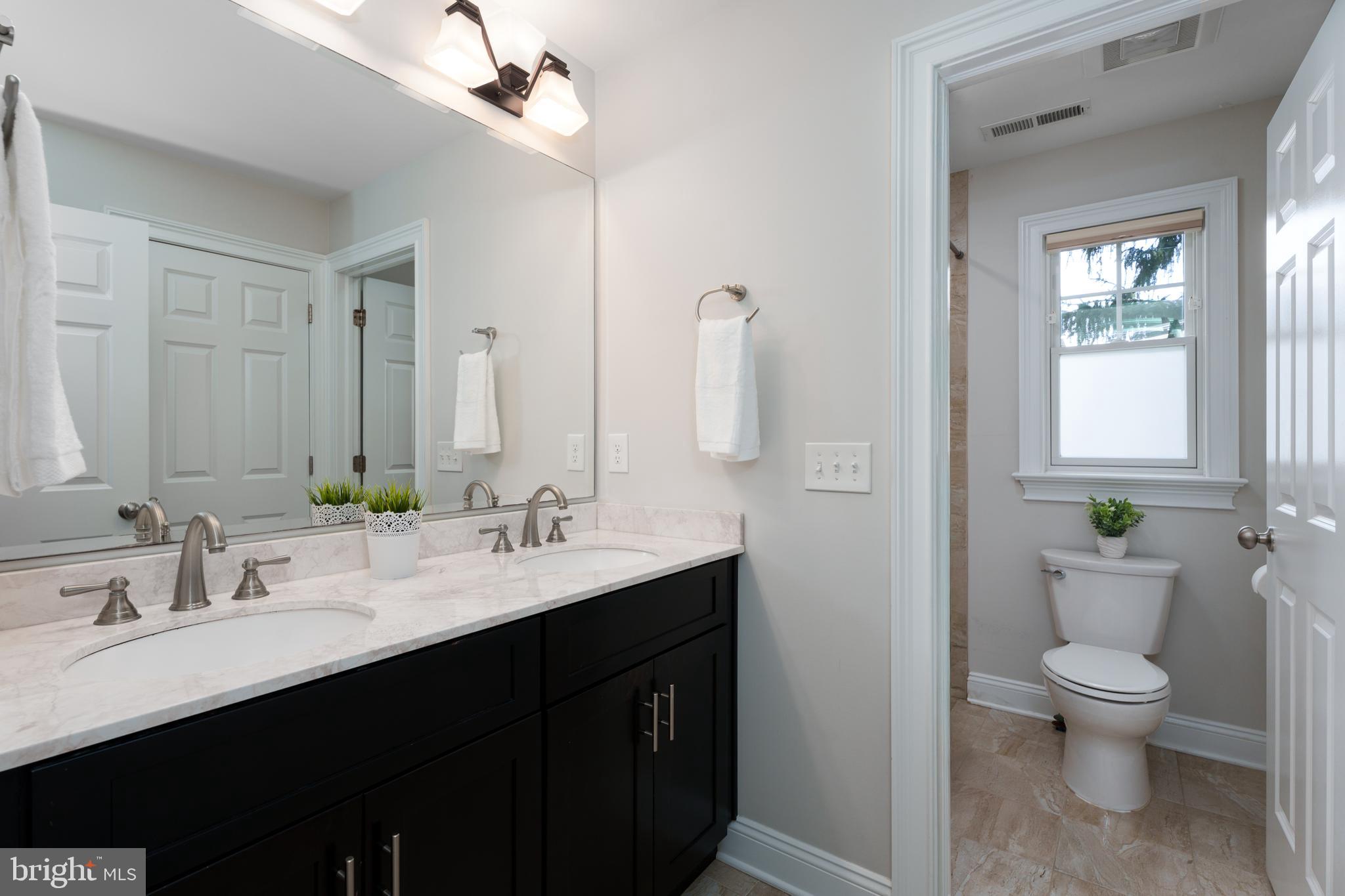 28 Hillside Road Princeton, NJ 08540 - Photo 24 of 31 a bathroom with a double vanity sink toilet and a mirror