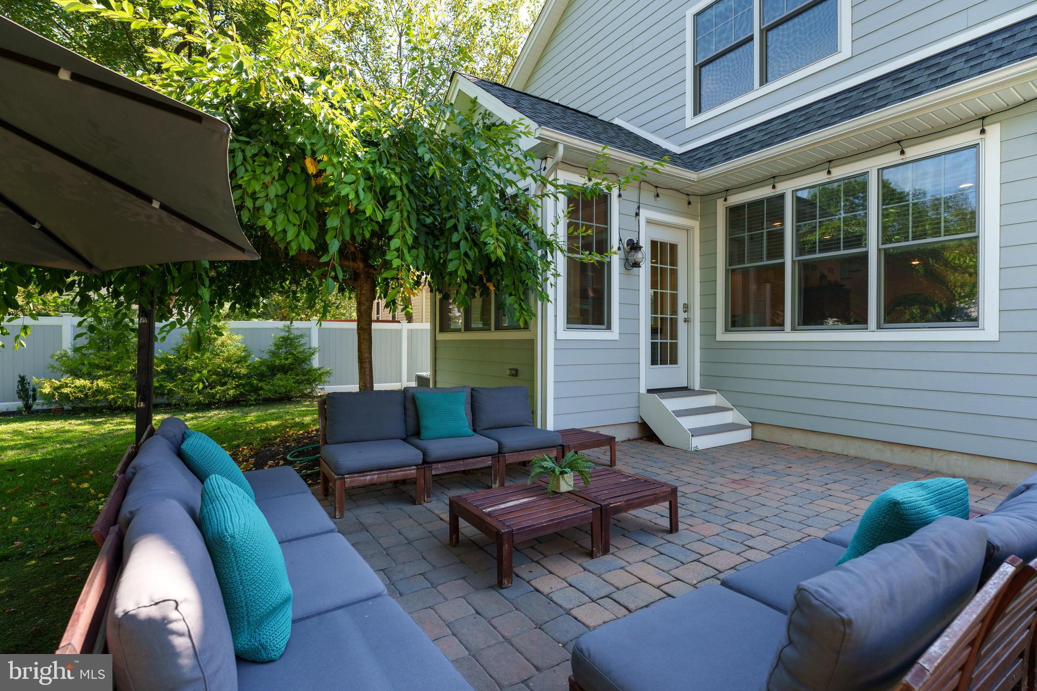28 Hillside Road Princeton, NJ 08540 - Photo 30 of 31 a view of a patio with couches table and chairs under an umbrella