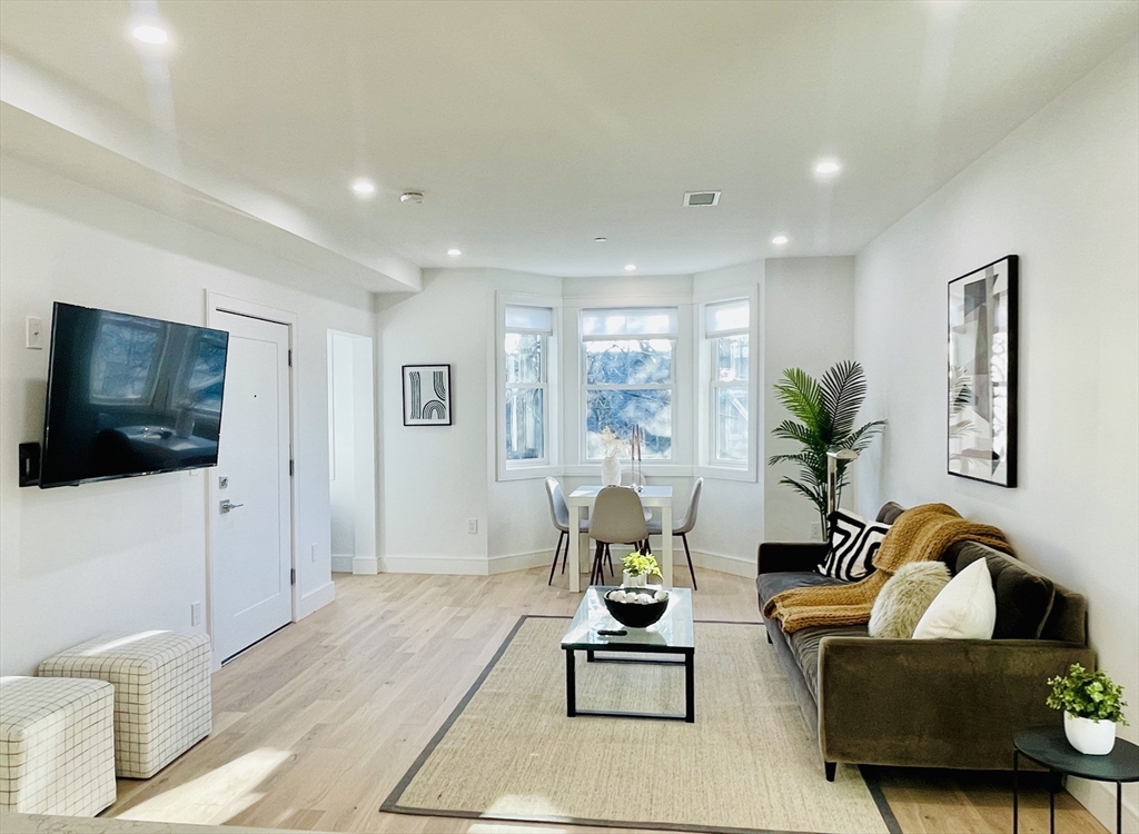 106 Webster Street, Unit 201 Boston, MA 02128 - Photo 6 of 33 a living room with furniture and a flat screen tv