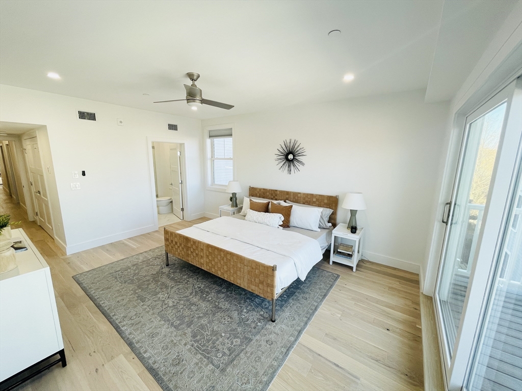 106 Webster Street, Unit 201 Boston, MA 02128 - Photo 10 of 33 a bedroom with a bed and a flat screen television