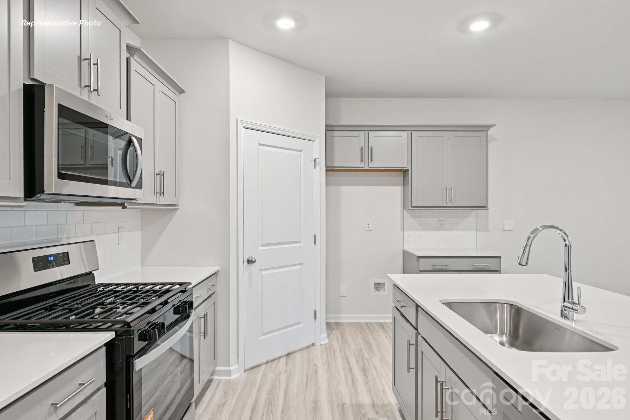 7881 Old Brk Road Sherrills Ford, NC 28673 - Photo 11 of 26 a kitchen with granite countertop a sink stove and refrigerator