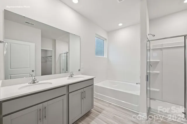 a bathroom with a tub sink double and mirror