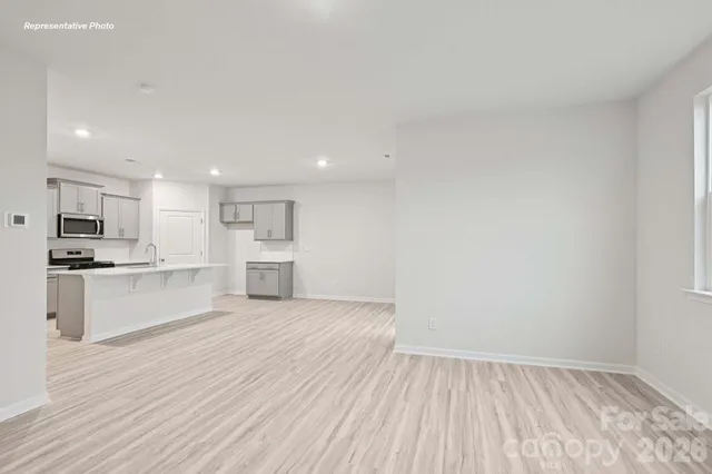 a view of kitchen with wooden floor and electronic appliances