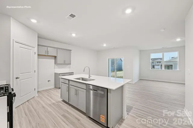a kitchen with a sink stove and refrigerator