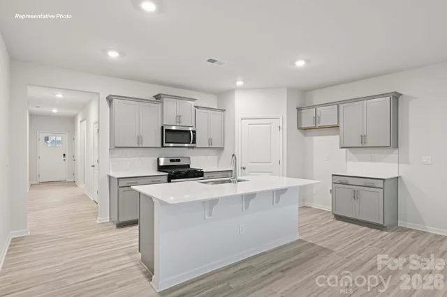 a kitchen with stainless steel appliances a sink stove and refrigerator