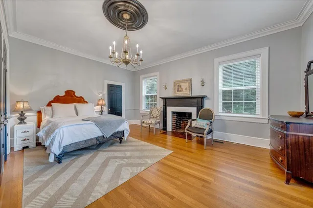 a bedroom with furniture fireplace and window