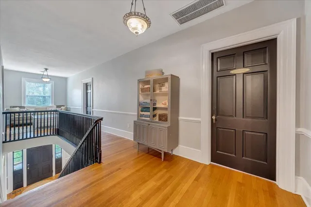 a bedroom with furniture and a chandelier