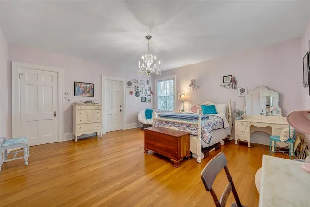 a bathroom with a tub a sink and a large mirror