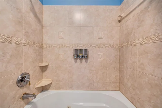 a view of a workspace with furniture and a chandelier fan