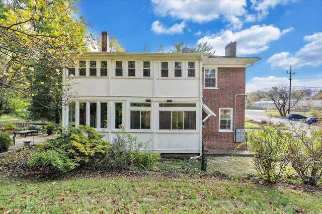 a view of a house with a yard porch and furniture