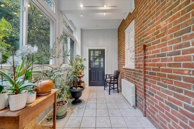 a lobby with furniture and potted plants