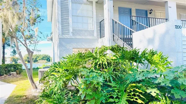 a view of a house with a flower garden