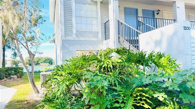 a view of a house with a flower garden