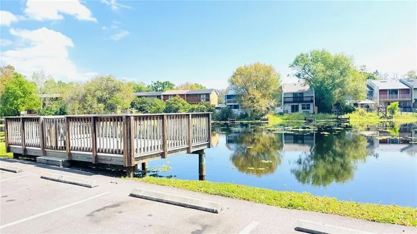 a view of a house with swimming pool next to a yard