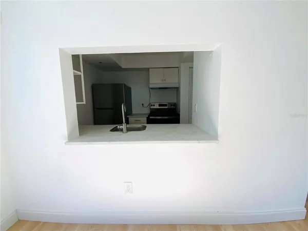 a living room with a bed and a dresser