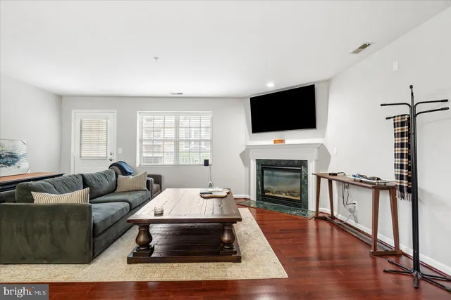 a living room with furniture fireplace and flat screen tv