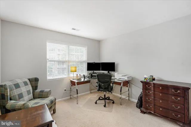 a view of a workspace with a window and couch