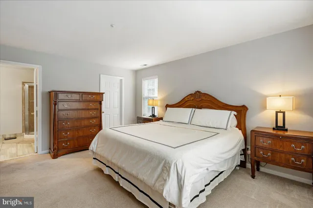 a bedroom with a bed and a night stand