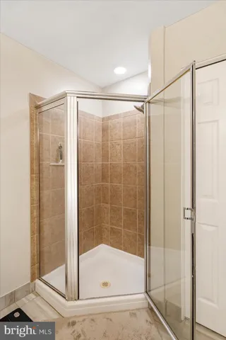 a bathroom with a glass shower door