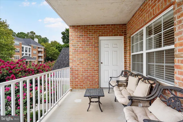 a view of a chair and tables in the balcony