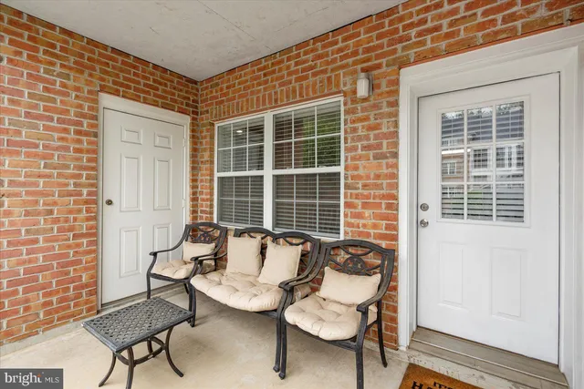 a balcony with couple of chairs and a window