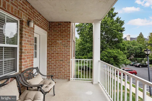 a balcony with table and chairs