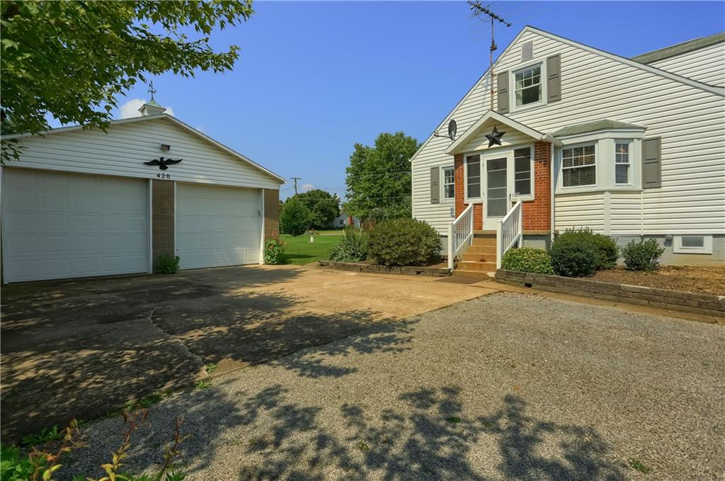 420 Big Knob Road Rochester, PA 15074 - Photo 23 of 24 a front view of a house with a yard and garage