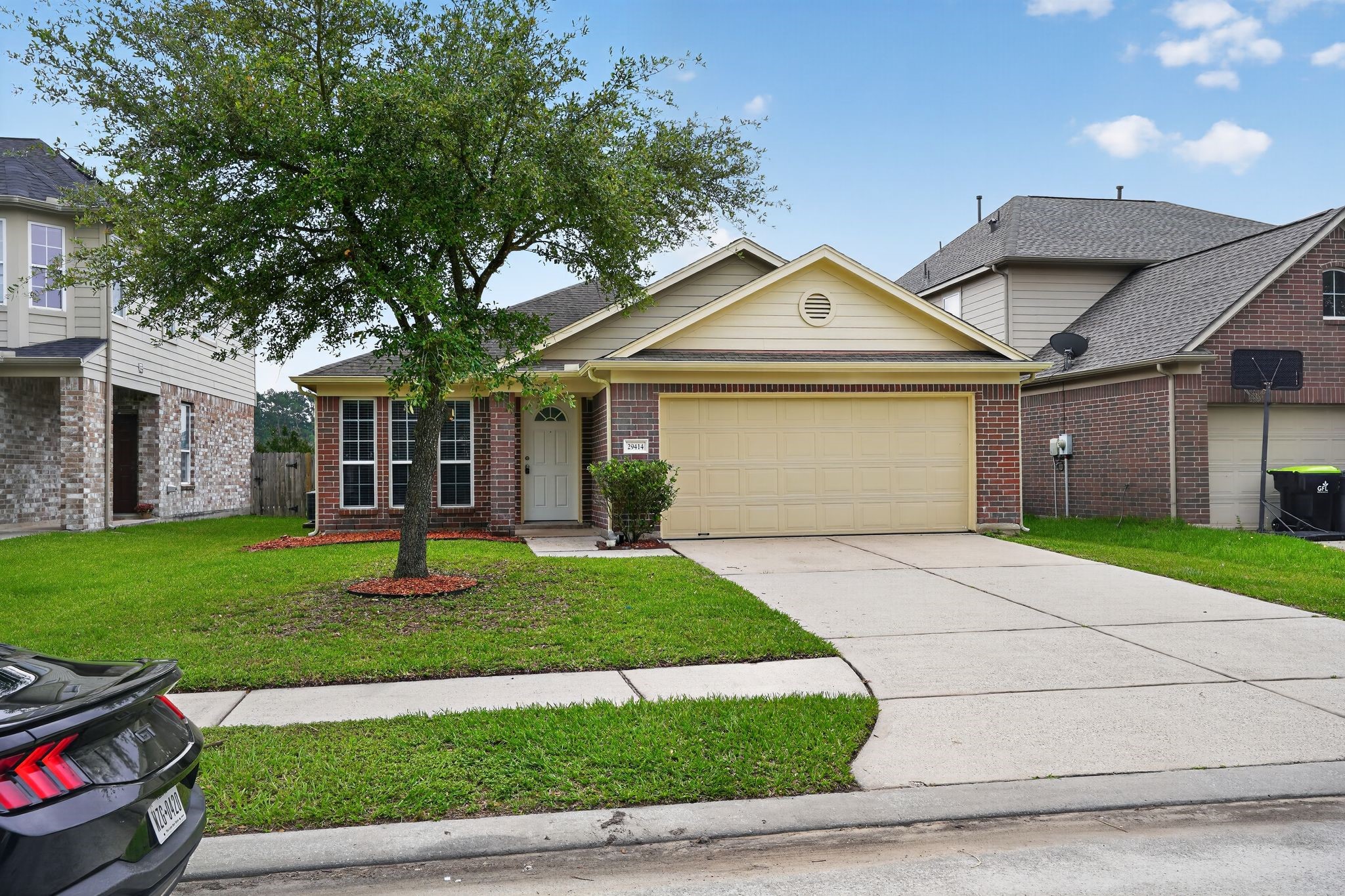 29414 Winton Wood Way Spring, TX 77386 - Photo 2 of 35 a front view of a house with a garden and trees