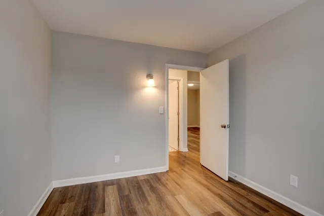 a view of an empty room and wooden floor