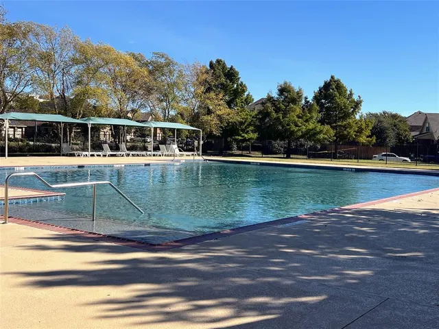 a view of a swimming pool with an outdoor space and seating area