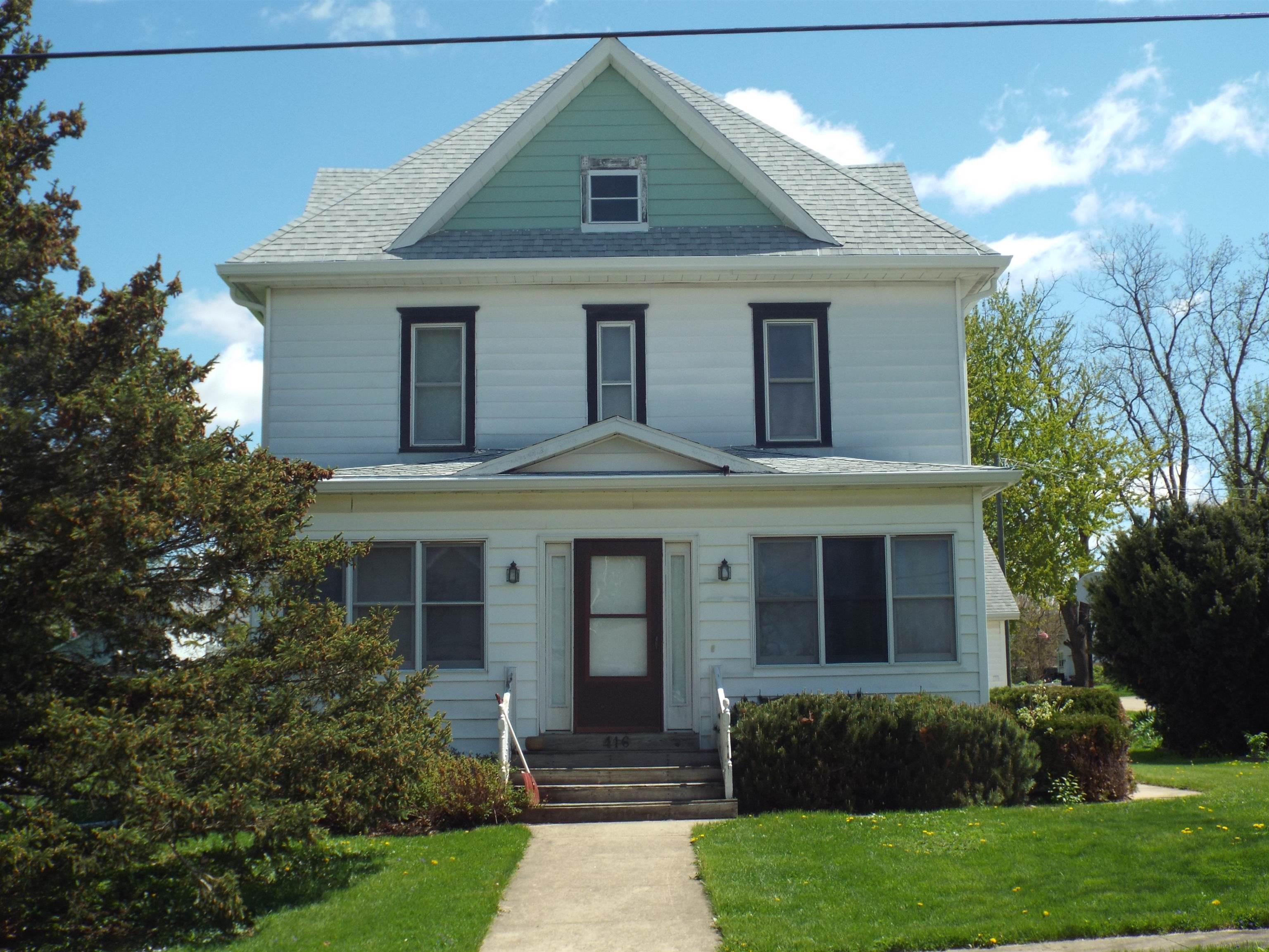 416 Chestnut Street Warren, IL 61087 - Photo 1 of 23 a front view of a house with a yard and potted plants