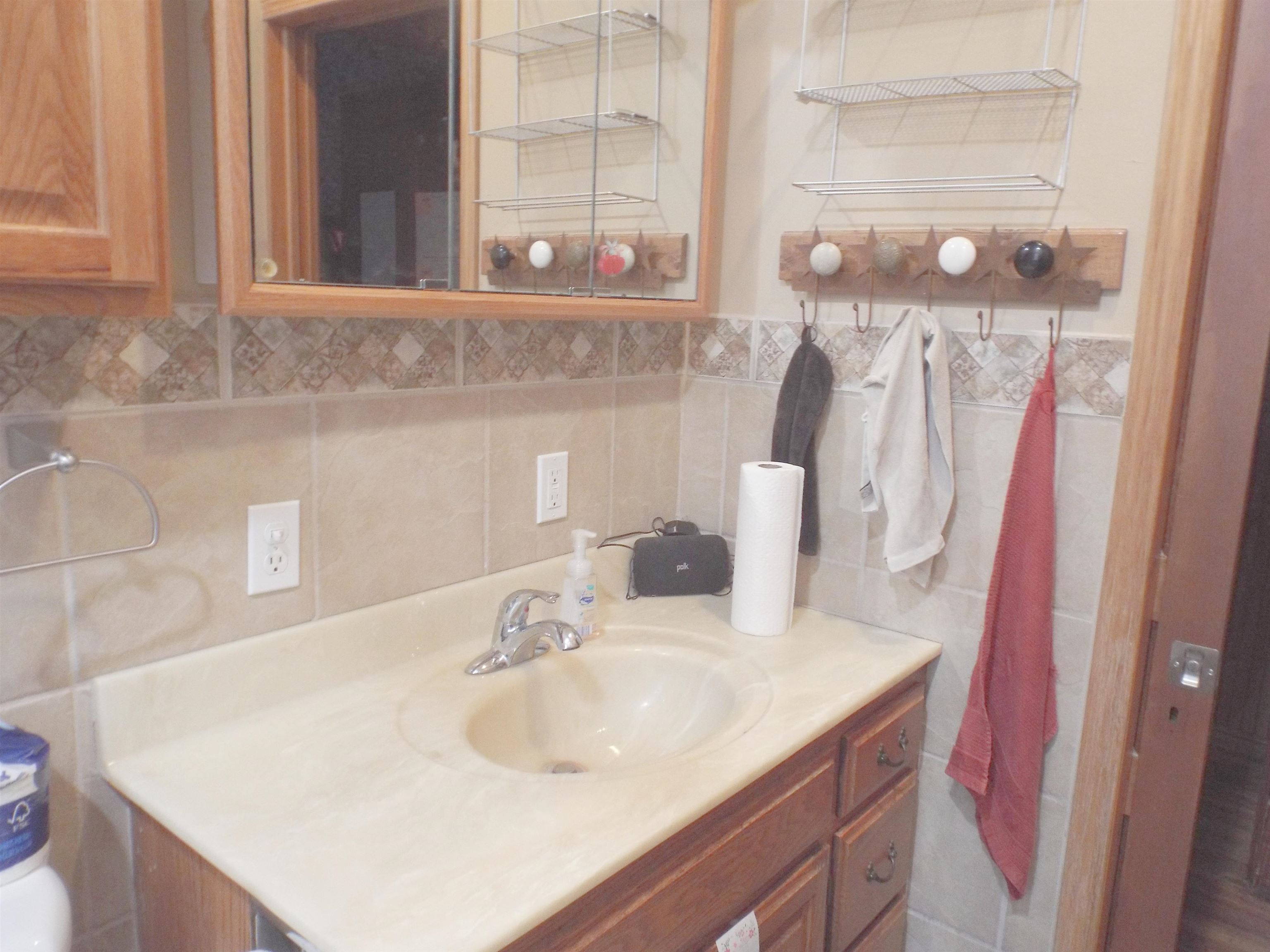416 Chestnut Street Warren, IL 61087 - Photo 14 of 23 a bathroom with a sink and a mirror