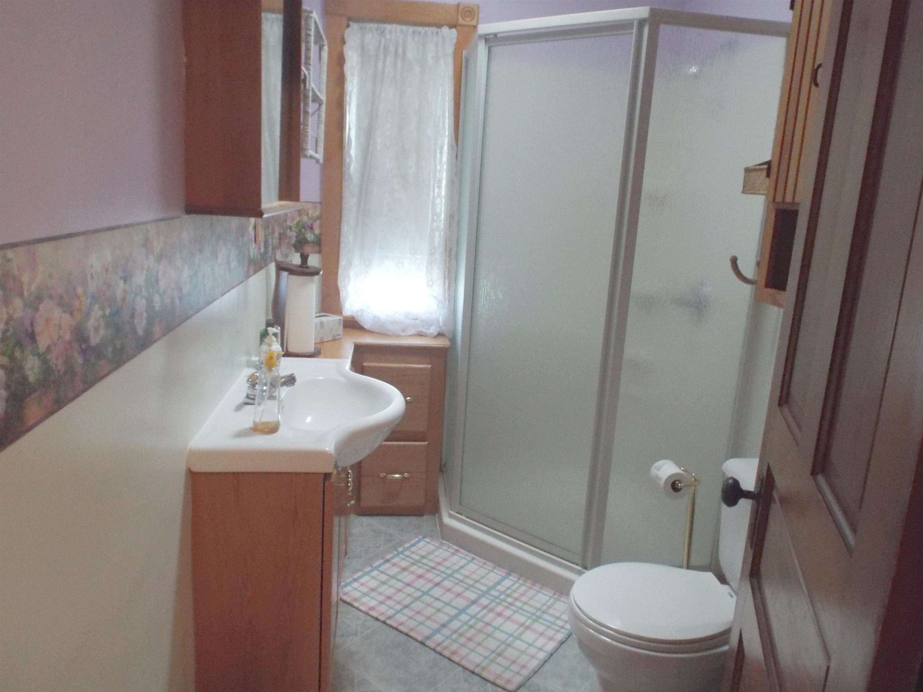416 Chestnut Street Warren, IL 61087 - Photo 15 of 23 a bathroom with a sink toilet and shower