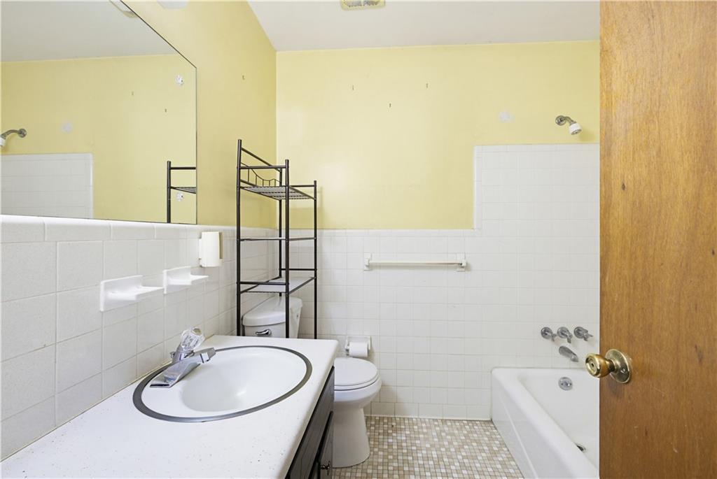4188 Cedar Valley Lane Conley, GA 30288 - Photo 13 of 28 a bathroom with a sink a toilet and shower
