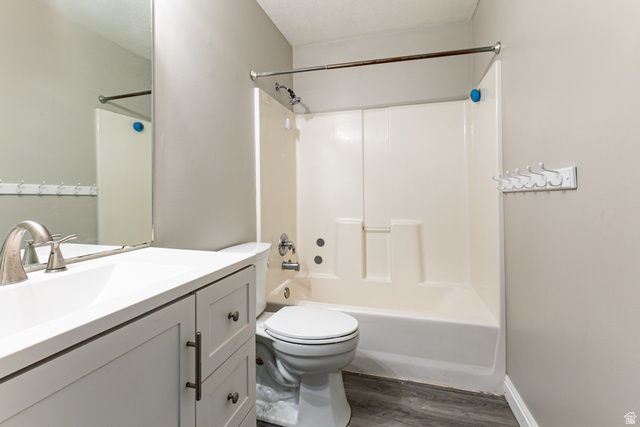 4239 West 5325th Street South Roy, UT 84067 - Photo 11 of 26 Full bathroom featuring a white vanity with integrated sink, brushed nickel faucet, and a large wall mirror