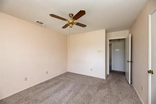 a view of a big room with closet and fan