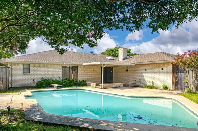 a view of a house with swimming pool and a porch