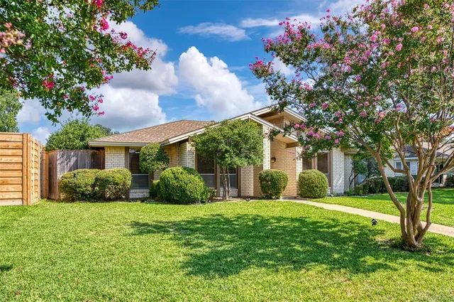 a view of a house with a tree in a yard