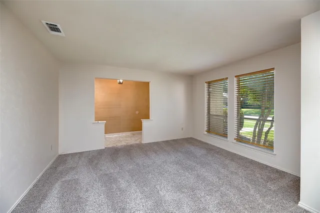 a view of an empty room with a window