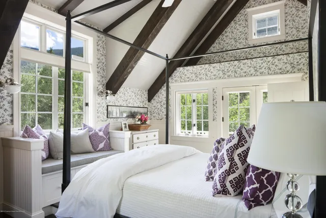 a living room with furniture a large window and a flat screen tv