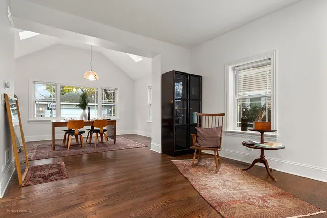 a living room with furniture and a table with wooden floor