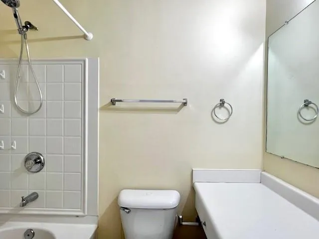 a bathroom with a toilet and shower