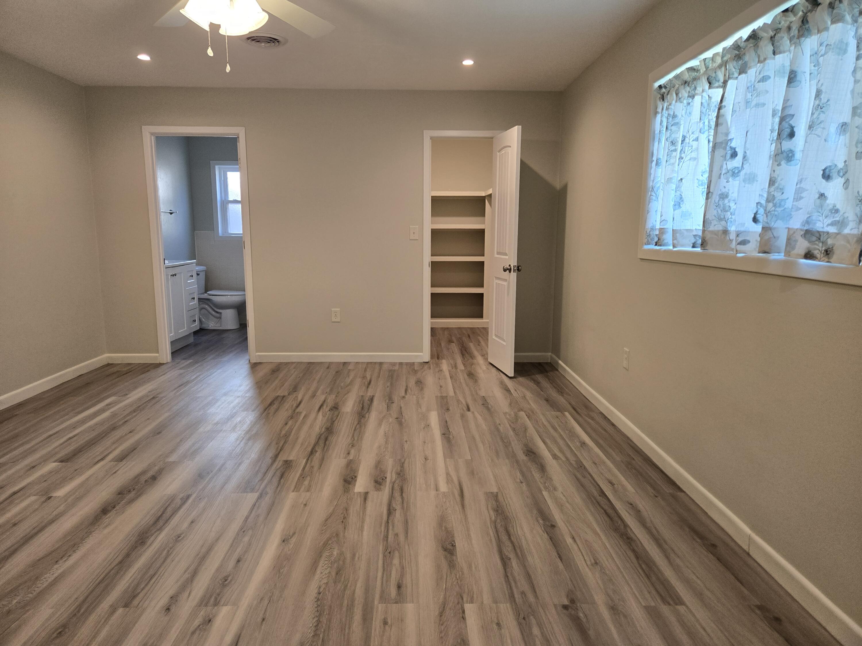 216 North 24th Street Lamesa, TX 79331 - Photo 12 of 27 wooden floor in an empty room with a window