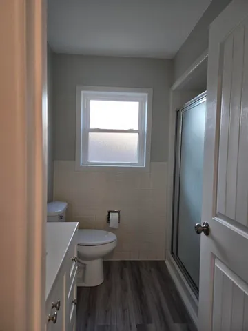 a view of room with wooden floor and staircase