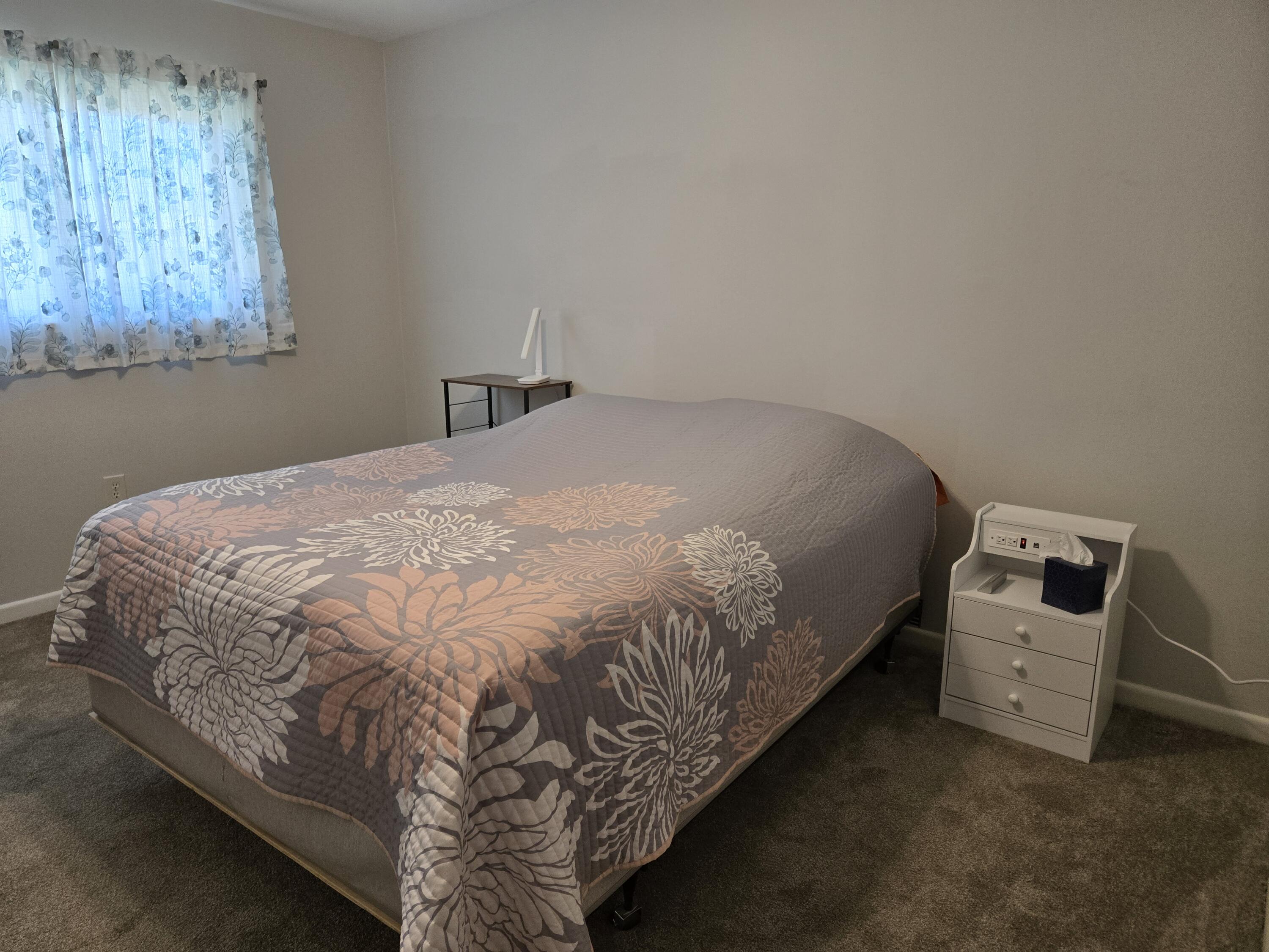 216 North 24th Street Lamesa, TX 79331 - Photo 17 of 27 a bed sitting in a bedroom next to a window