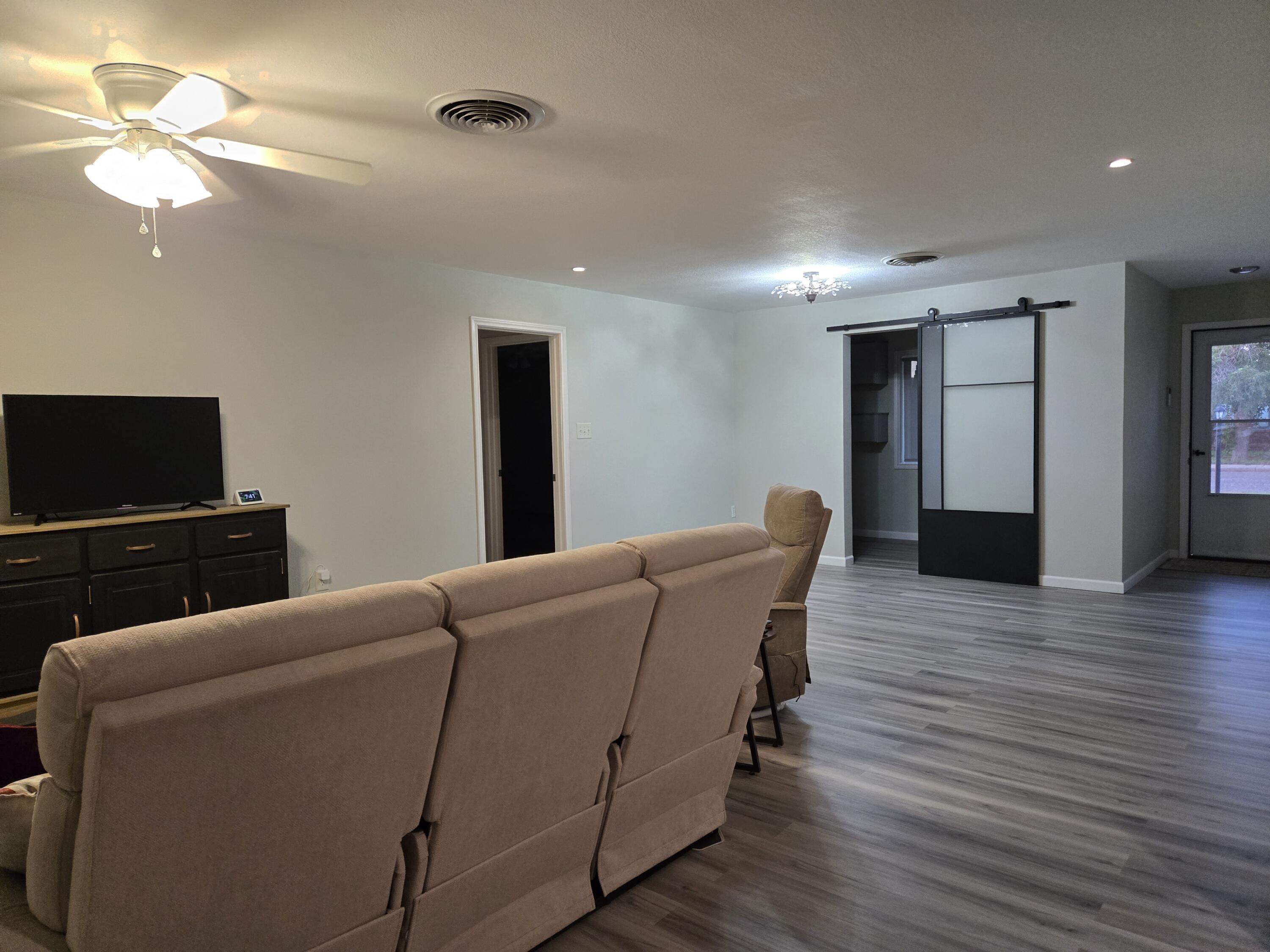216 North 24th Street Lamesa, TX 79331 - Photo 2 of 27 a living room with furniture and a flat screen tv