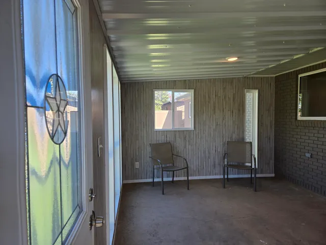 a view of a livingroom with furniture and a window